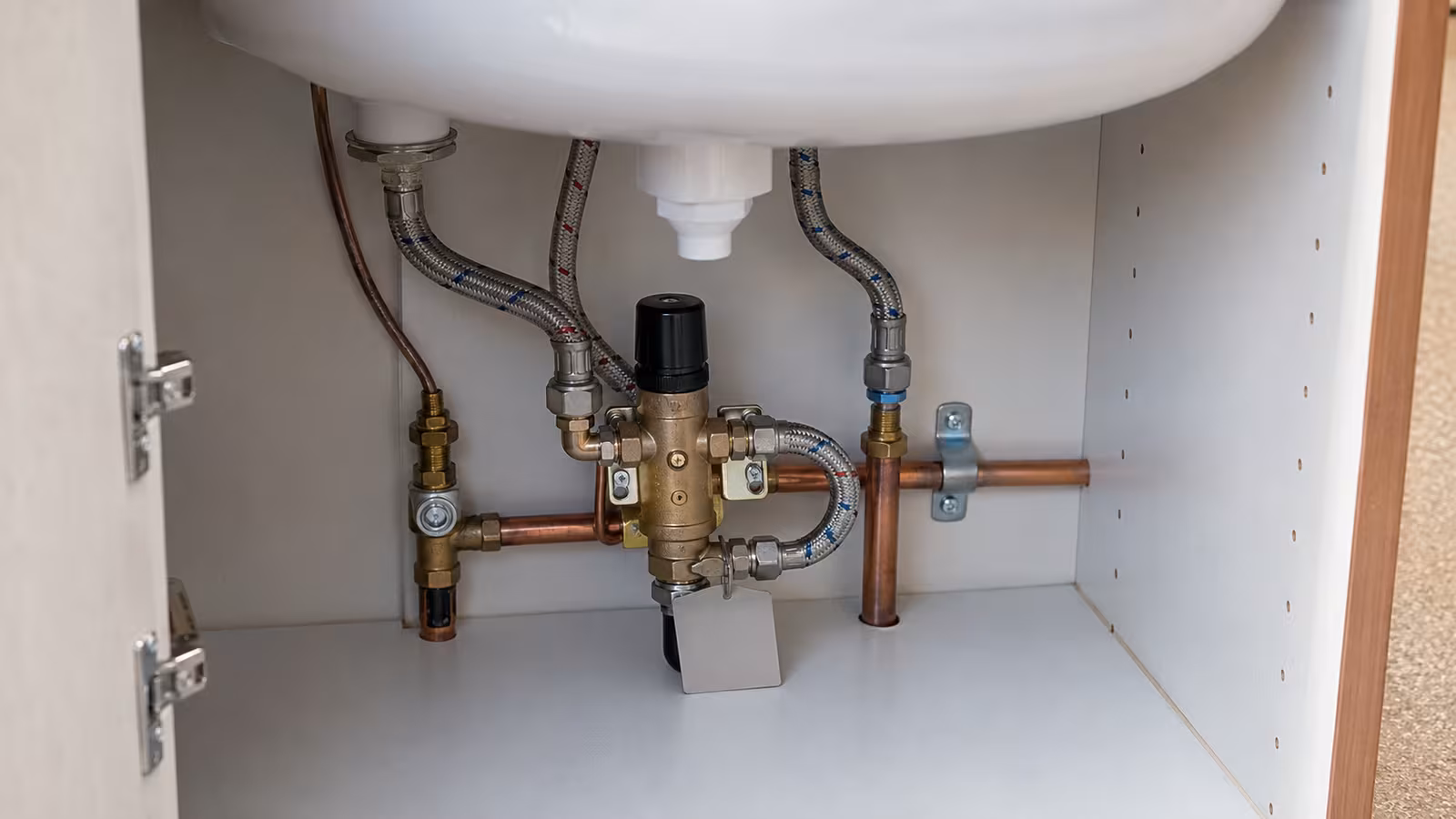 Thermostatic mixing valve installed under a childcare basin